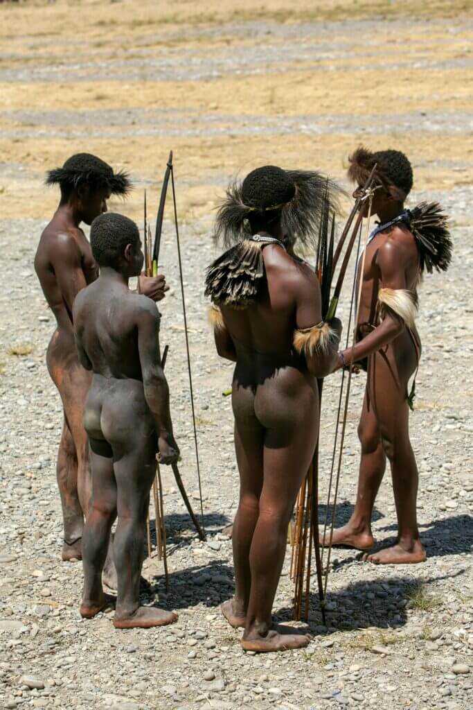 Healing Practices A group of indigenous tribesmen in Papua, Indonesia, participating in a traditional cultural gathering.