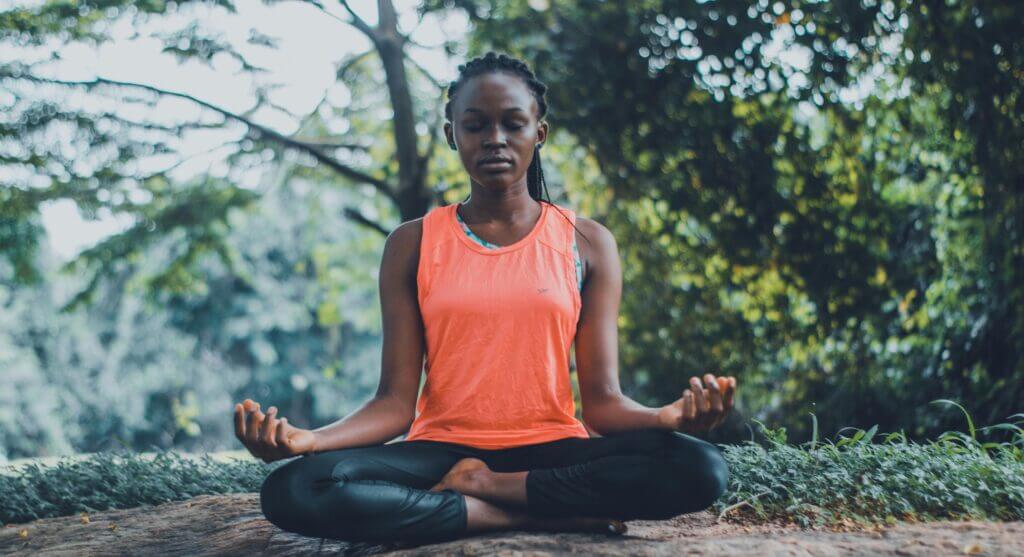 Ayurveda The Science of Life - A woman meditating peacefully outdoors 